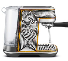 A promotional shot of a coffee machine seen from the side