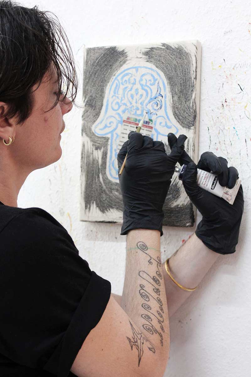 Elif Saydam at work on a small painting