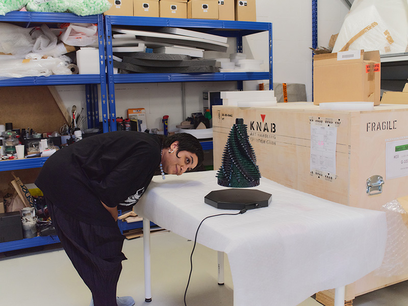 Monira Al Qadiri looking at one of her floating sculptures