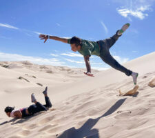 Photo of kids jumping in sand