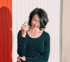 A portrait of a woman in front of a white and red wall