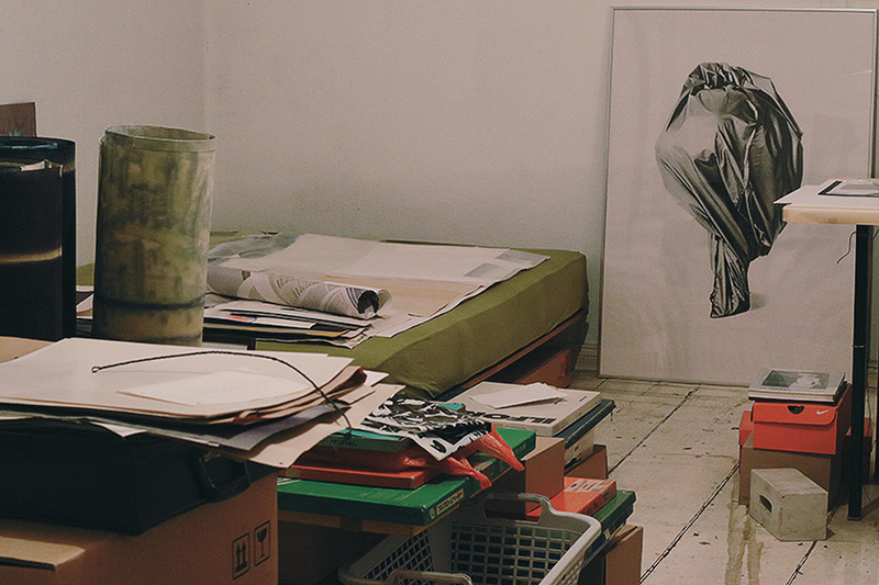 a room with framed images and boxes stacked up show Frenzel's massive archival collection in her studio 