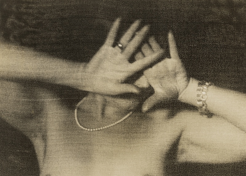 a black and white image of a woman that is hiding her face with her hands 