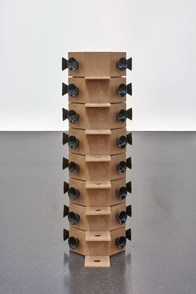 a woodern structure with ceramic parts that look like speaker
