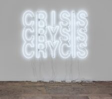 A white neon sign on a beige wall
