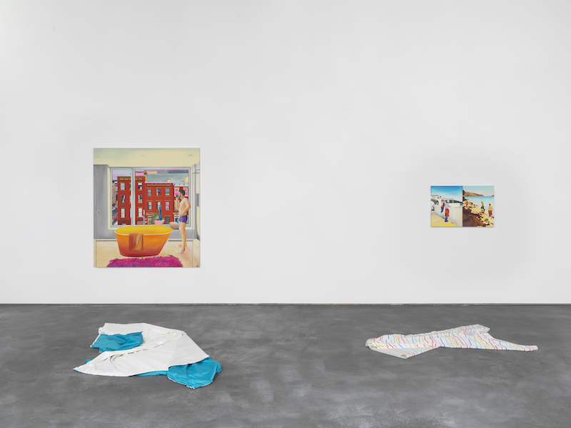 An installation view of the works ‘Eli in Berry St.’, ‘Two chefs on a cigarette break in Marseille’ and ‘3 boys in Balandra’ by Navot Miller with sheets that had previously hung in front of the paintings lying on the floor.