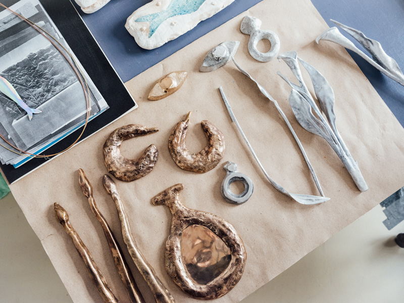 Photo of small bronze and aluminium casts and sculptures sitting on a desk