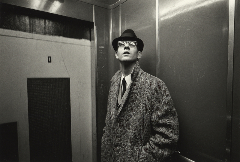 A fashionable man with a head and sun glasses in an elevator