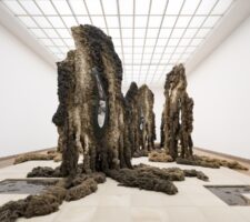 monumental installation with brown sculptures made of textile fibers