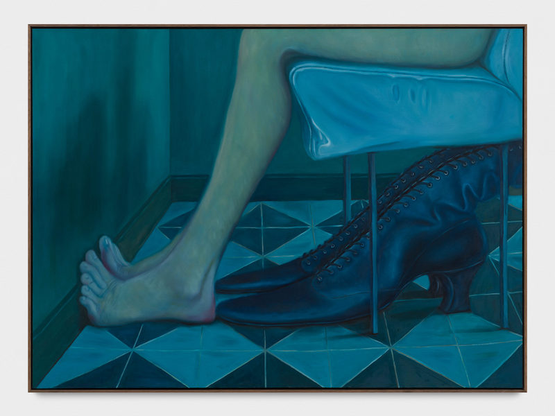 an image with someone sitting on a chair and their legs, boots under the chair