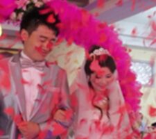 A just married couple with pink decorations hearts