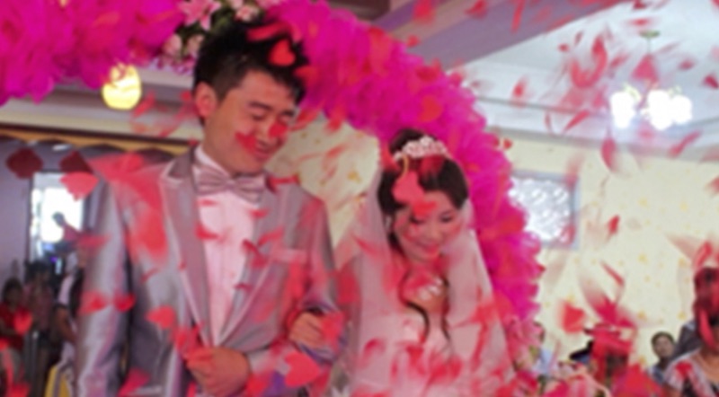 A just married couple with pink decorations hearts